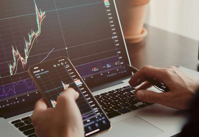 trader-analyzing-stock-trading-graph-phone-app-2022-02-05-11-02-20-utc